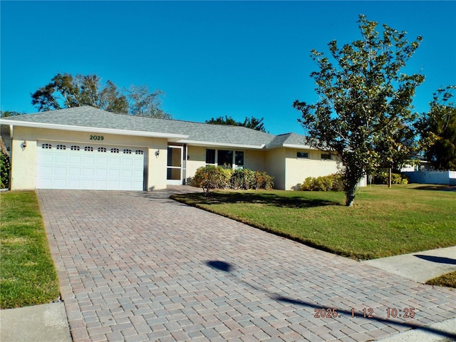 ranch-style home with a front lawn and a garage