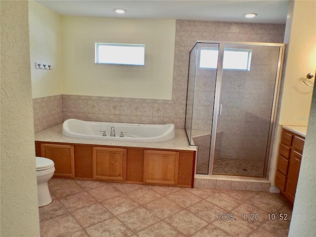 full bathroom featuring tile patterned floors, toilet, vanity, and separate shower and tub