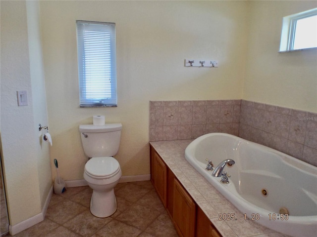 bathroom with toilet, tile patterned floors, and a bathing tub