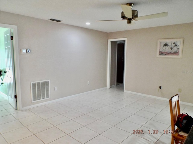 empty room featuring ceiling fan and light tile patterned floors