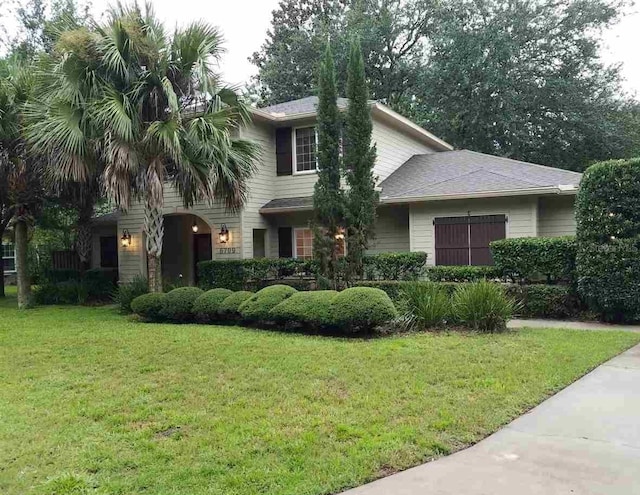 view of front facade with a front lawn and a garage