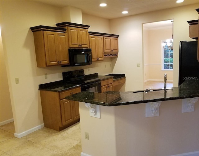 kitchen featuring sink, an inviting chandelier, kitchen peninsula, dark stone countertops, and black appliances