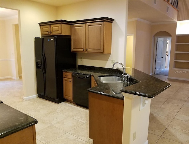 kitchen with sink, kitchen peninsula, dark stone countertops, light tile patterned flooring, and black appliances