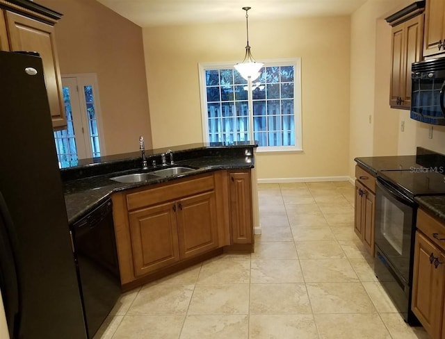 kitchen featuring dark stone counters, sink, light tile patterned floors, and black appliances