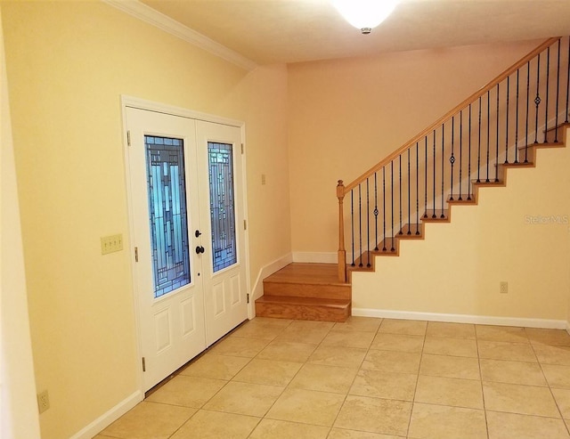 tiled foyer entrance with crown molding