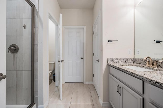 bathroom featuring vanity, toilet, and an enclosed shower