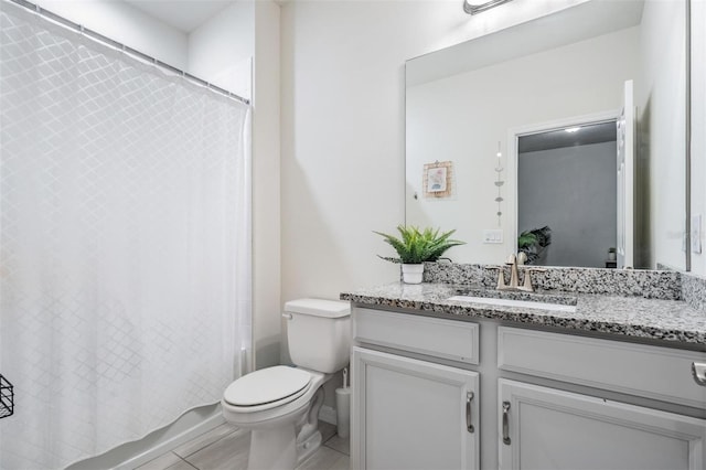 full bathroom with tile patterned floors, vanity, shower / tub combo, and toilet