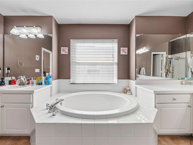 bathroom featuring plus walk in shower and vanity