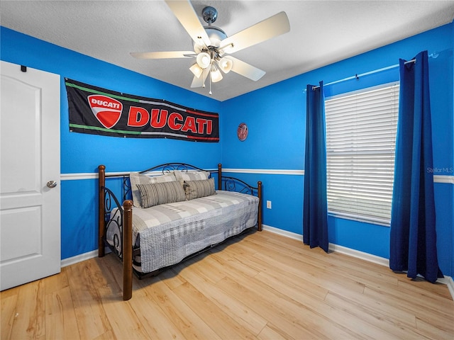 bedroom with light wood-type flooring and ceiling fan