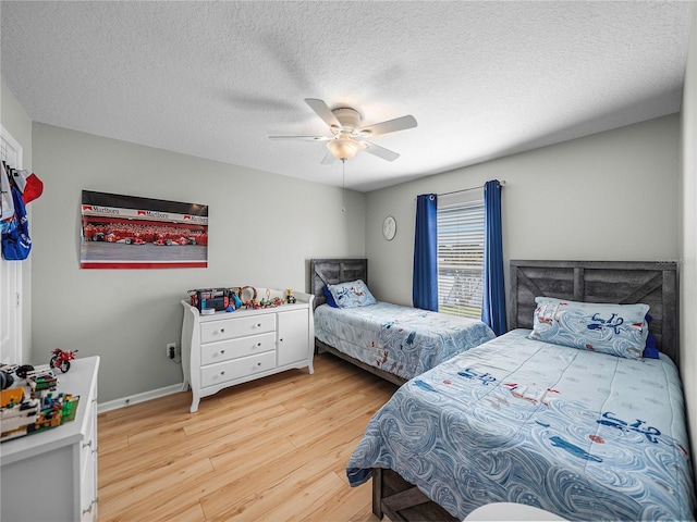 bedroom featuring a textured ceiling, ceiling fan, and light hardwood / wood-style floors