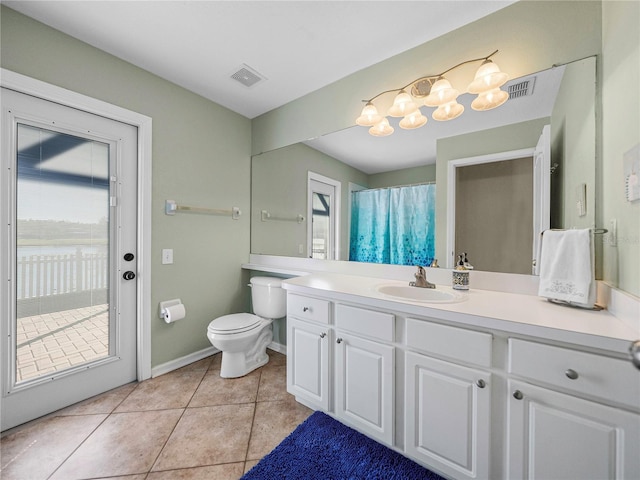 bathroom with toilet, tile patterned floors, and vanity