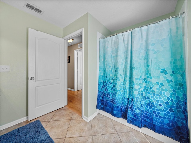 bathroom with tile patterned floors