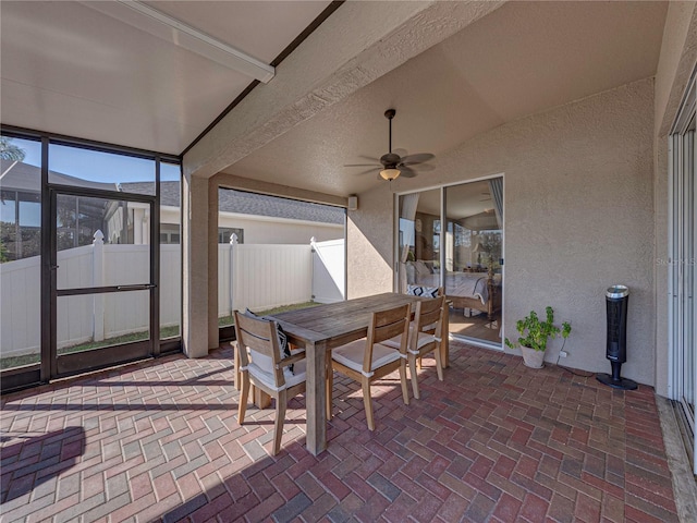 sunroom featuring ceiling fan and lofted ceiling