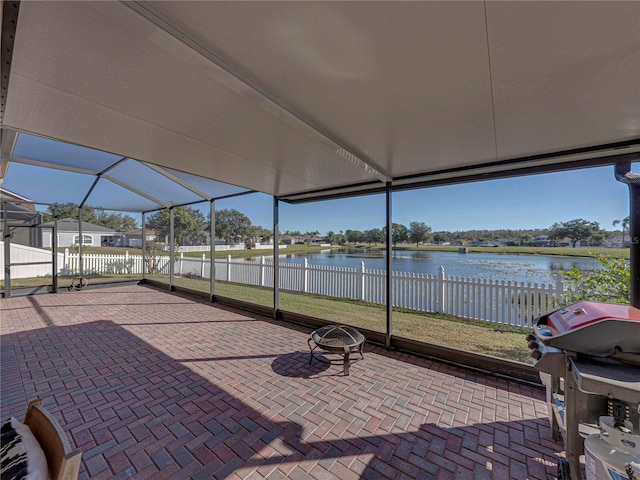 unfurnished sunroom featuring a water view