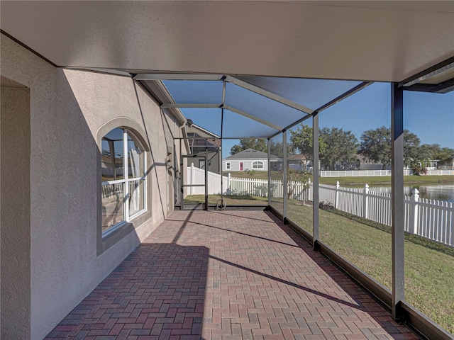 unfurnished sunroom with a water view