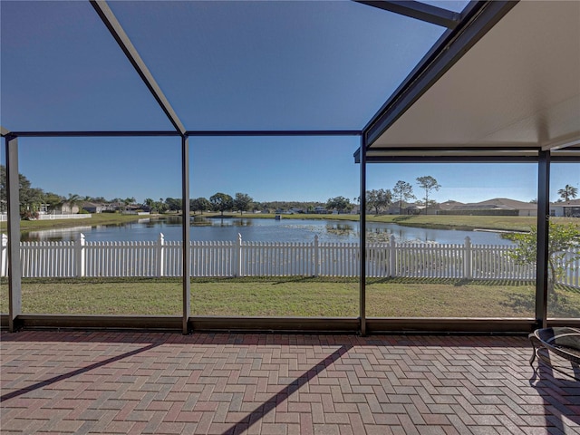 unfurnished sunroom with a water view