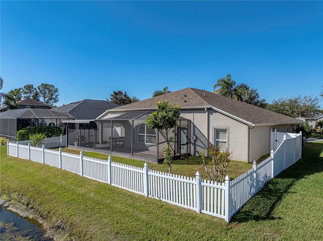 view of front of house with a lanai and a front lawn