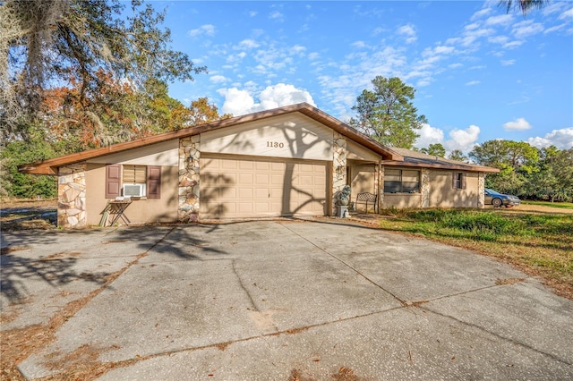 ranch-style home with a garage and cooling unit