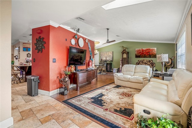 living room featuring ceiling fan, ornamental molding, and vaulted ceiling