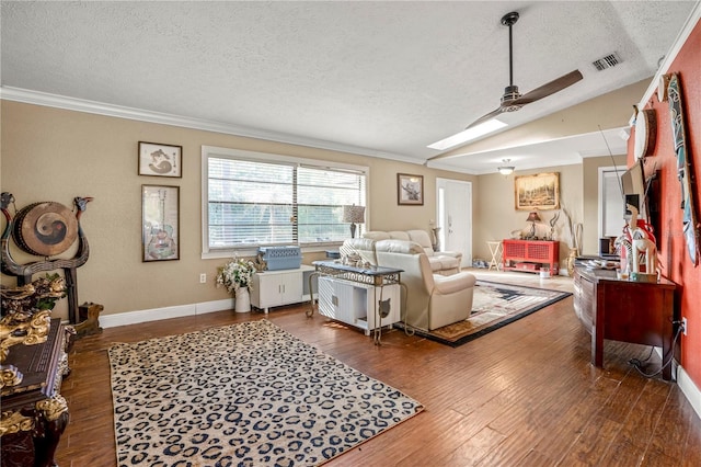 living room with wood-type flooring, a textured ceiling, ceiling fan, and ornamental molding