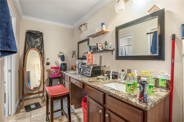 interior space featuring crown molding, sink, and light stone countertops