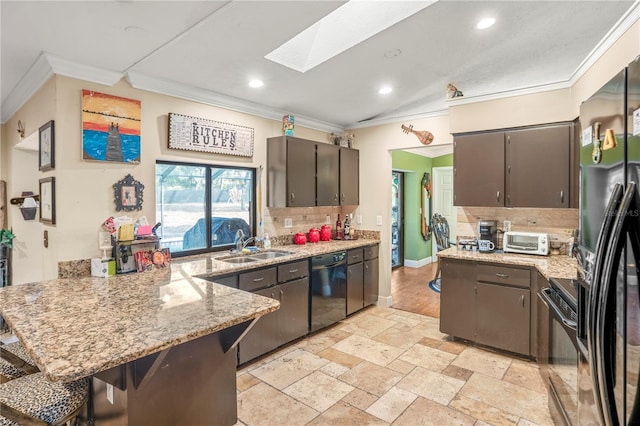 kitchen featuring black appliances, dark brown cabinets, ornamental molding, and backsplash