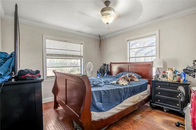 bedroom with hardwood / wood-style floors, ceiling fan, ornamental molding, and multiple windows