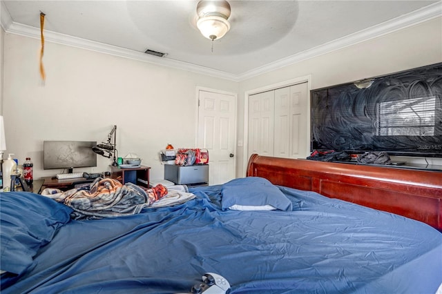 bedroom with ceiling fan, a closet, and crown molding