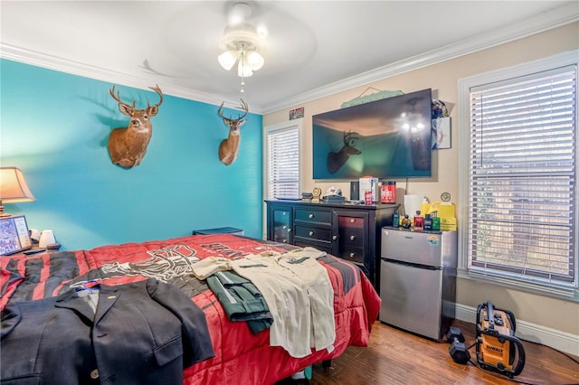 bedroom with ceiling fan, stainless steel refrigerator, and multiple windows