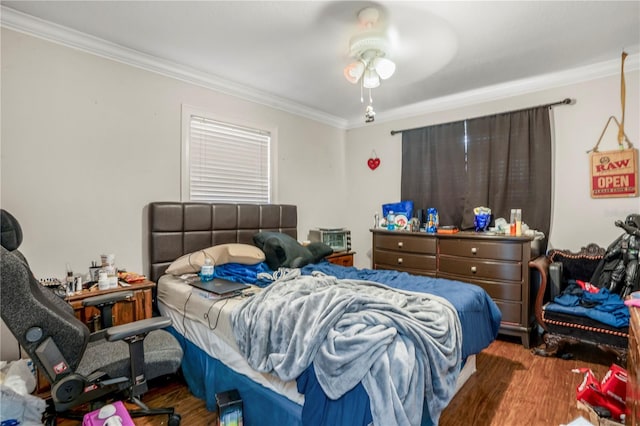 bedroom with ceiling fan, dark hardwood / wood-style floors, and ornamental molding