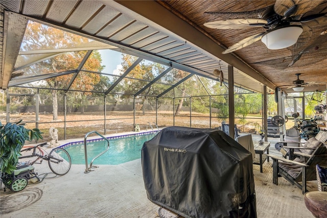 view of pool with a lanai, a grill, and a patio area