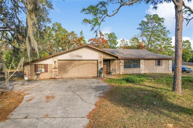 ranch-style home featuring cooling unit and a garage