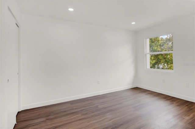 spare room with dark hardwood / wood-style floors