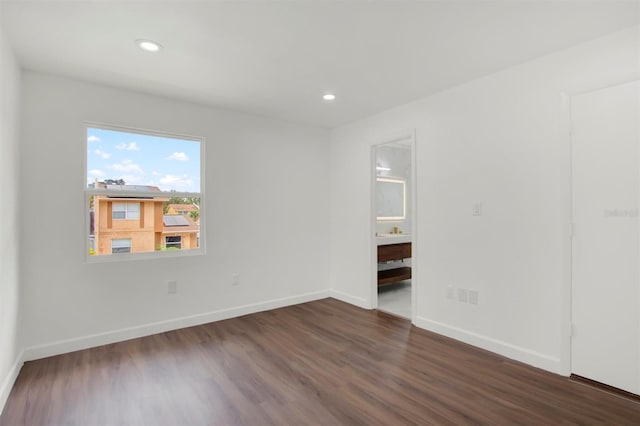 spare room with dark wood-type flooring