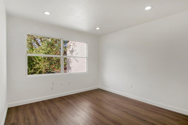 spare room featuring dark wood-type flooring