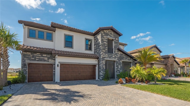 mediterranean / spanish-style house with a garage and a front lawn