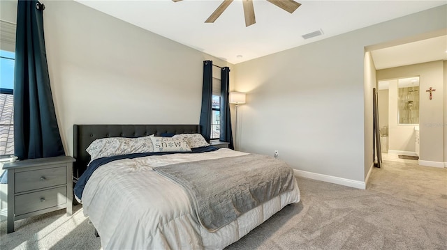 carpeted bedroom featuring ceiling fan, connected bathroom, and multiple windows