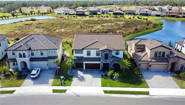 birds eye view of property with a water view