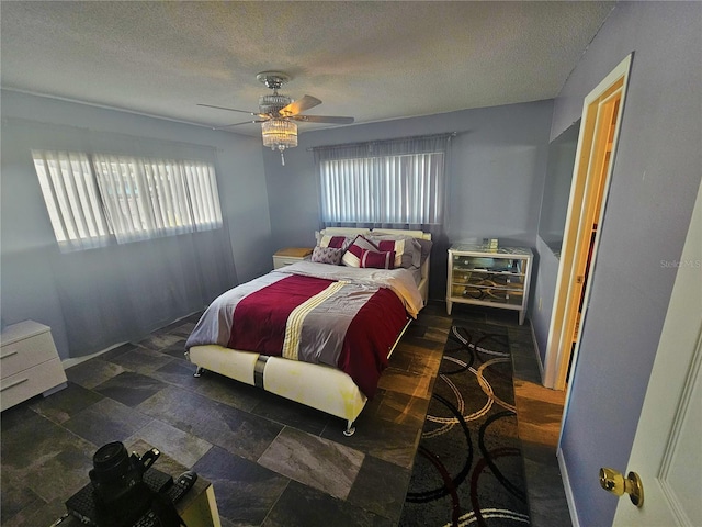 bedroom featuring ceiling fan and a textured ceiling