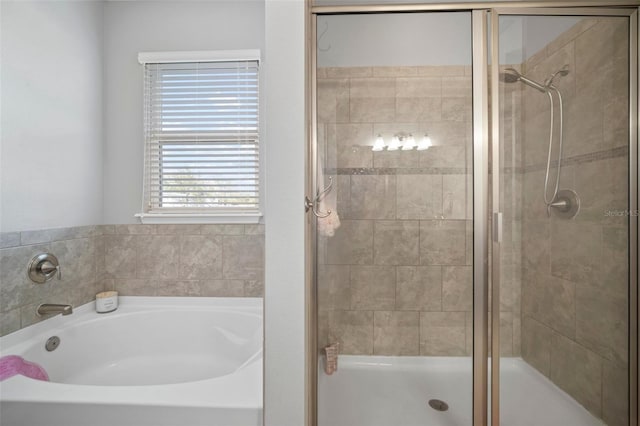 bathroom with shower with separate bathtub