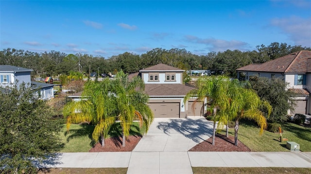 view of front of home with a front lawn and a garage