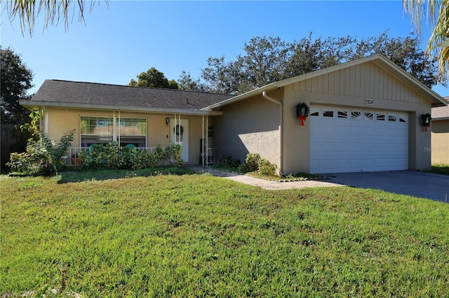 ranch-style home with a front yard and a garage