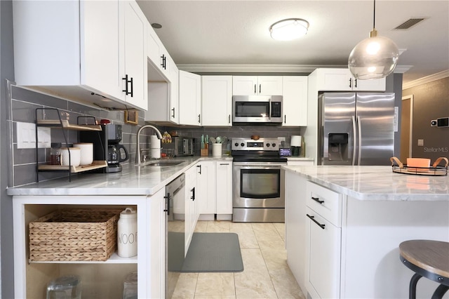 kitchen featuring white cabinetry, sink, ornamental molding, and stainless steel appliances