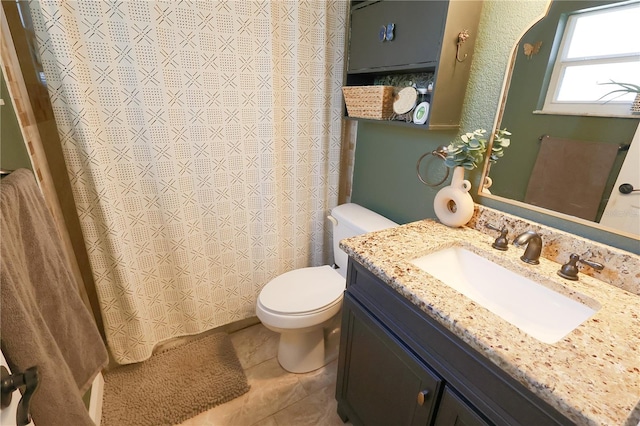 bathroom featuring tile patterned flooring, vanity, and toilet