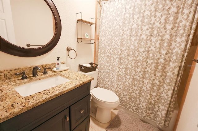 bathroom with tile patterned floors, vanity, and toilet