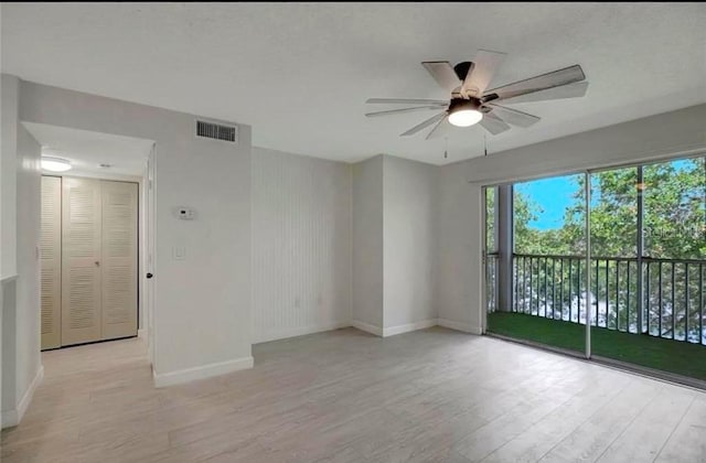 unfurnished room with ceiling fan and light wood-type flooring