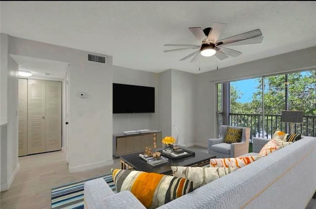 living room featuring ceiling fan and light wood-type flooring