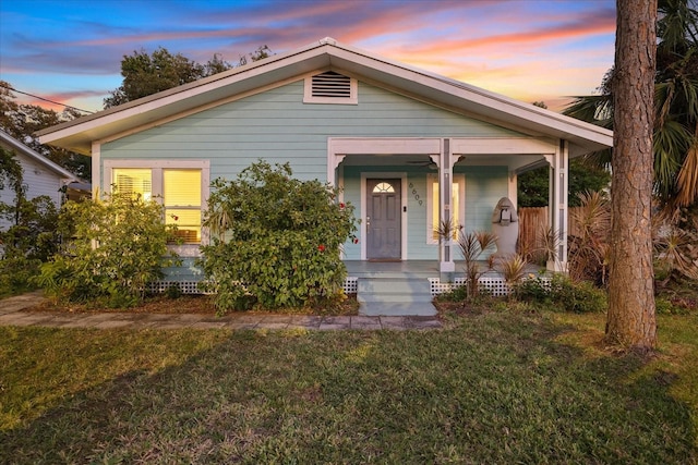 view of front of home with a lawn and covered porch