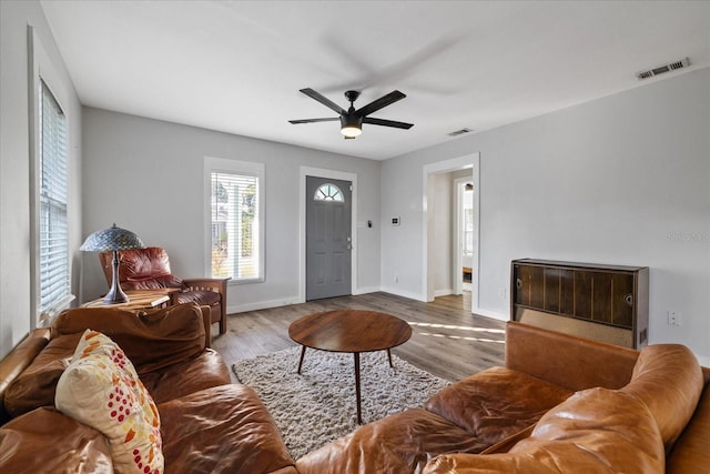 living room featuring ceiling fan and wood-type flooring