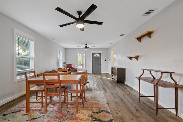 dining area with ceiling fan and light hardwood / wood-style floors